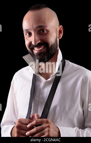 Handsome hispanic man smiling and looking at camera Stock Photo
