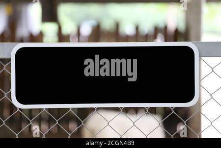 Black blank sign on the fence and have copy space for design. Stock Photo