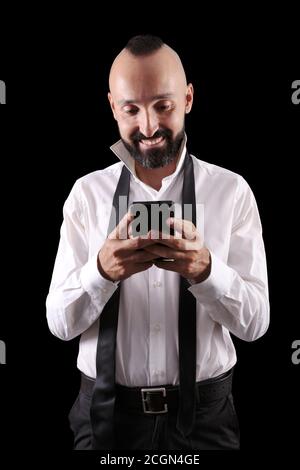 Happy hispanic man chatting or reading with a smile Stock Photo