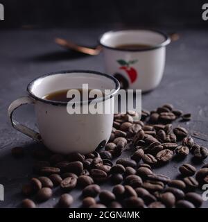 Cup of coffe and coffee beams Vintage in Dark Background Stock Photo