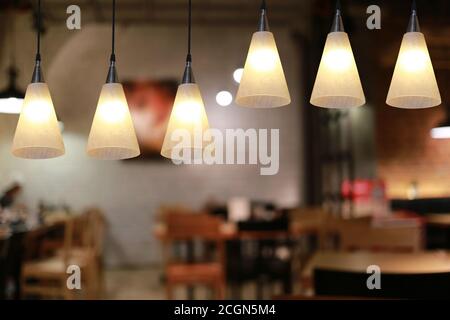 Modern lamp hanging from the ceiling of the restaurant for design in your work Interior concept. Stock Photo