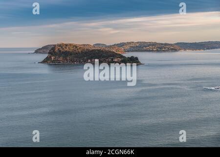 Sunset seascape over Broken Bay looking out over Lion Island and Barrenjoey Headland in the distance from Mount Ettalong Lookout at Pearl Beach on the Stock Photo