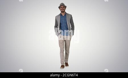 Young Asian tourist man wearing hat walking with hands in pocket Stock Photo