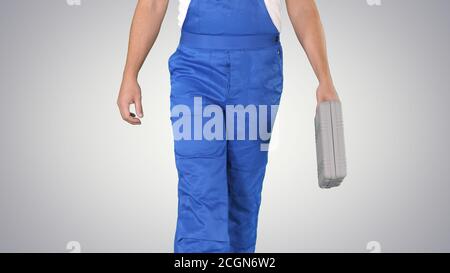 Carpenter walking on gradient background. Stock Photo