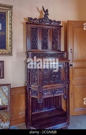 Amboise, France - October 31, 2013: Carved wooden cabinet with the salamander motif on the top, at chateau du clos luce, Amboise, France, home of Leon Stock Photo