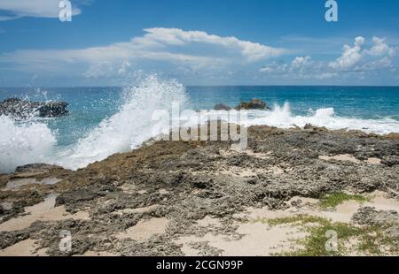 Powerful Caribbean Sea waves rushing the limestone tide pools in the Monk's Bath area on the coast of Frederiksted on St. Croix in the USVI Stock Photo