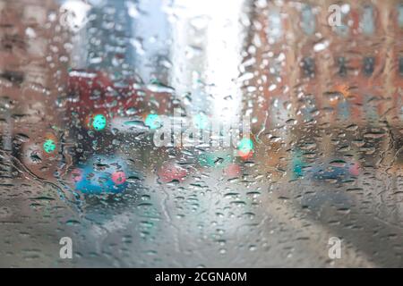 Downtown Calgary skyline during rainshower with raindrops on car window Stock Photo