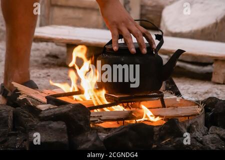 coffee pot boiling over an open fire cowboy flame smoke caffine wild west  Stock Photo - Alamy