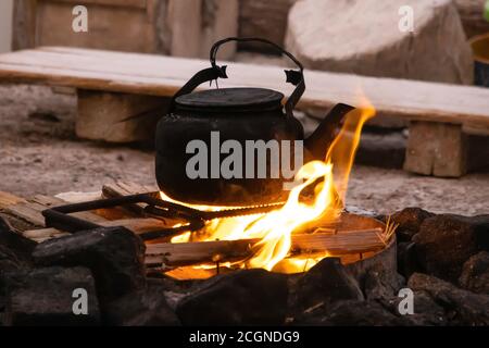 coffee pot boiling over an open fire cowboy flame smoke caffine wild west  Stock Photo - Alamy