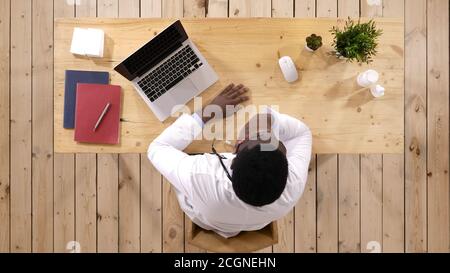 Young doctor at his working place smiling. Stock Photo
