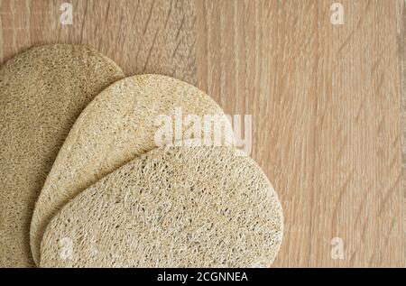 Natural loofah kitchen dish washing sponges. Eco friendly dishwashing sponge on a table, top view. Biodegradable dishwashing scrub pad. Stock Photo