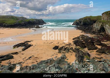 Porth Dafarch is a bay on Holy Island, North Wales. The geology is composed of Precambrian rocks. The beach shows people social distancing. Stock Photo