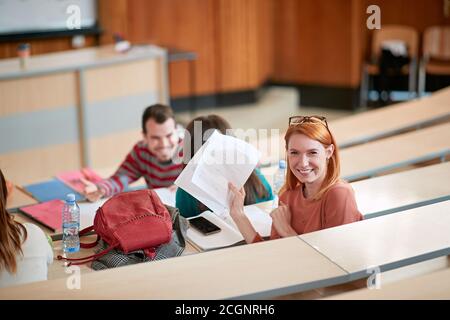 Young female student in an amphitheatre happy about her scores of the exam Stock Photo
