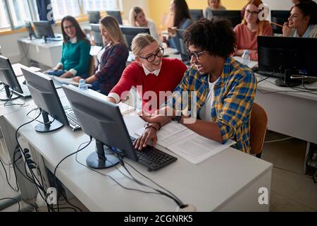 Students having fun at an informatics lecture in the university computer classroom Stock Photo