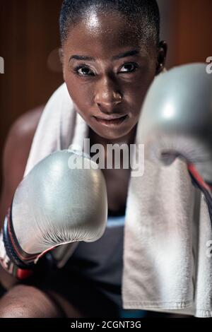 Female boxer in a locker room posing ready for a fight Stock Photo