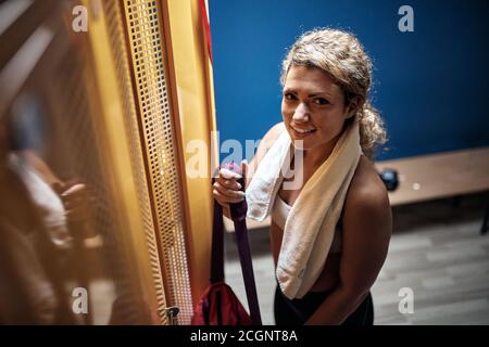 Young sporty girl posing in a locker room before training Stock Photo