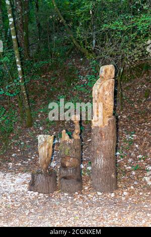 inlaid wooden totem in the shape of an owl positioned in the woods Stock Photo