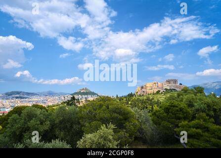 View of Acropolis hill with Propylaea and Parthenon and hill of Lycabettus in background in Athens, Greece from Pnyx hill in summer daylight with grea Stock Photo