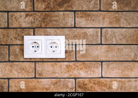 Power socket on the stone brick wall with copy space. Stock Photo