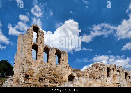 View of Odeon of Herodes Atticus theater on Acropolis hill, Athens, Greece, at bright blue sky and super clouds. Classic ancient Greek theater ruins Stock Photo