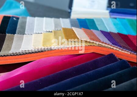 A table filled with soft luxury colorful folded velvet samples Stock Photo