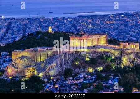 Close view of Acropolis hill with Parthenon and Erechtheion and Philoppapos monument at night, Athens, Greece. UNESCO world heritage site. Stock Photo