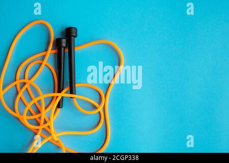 Skipping rope on blue background. Skip rope. Stock Photo