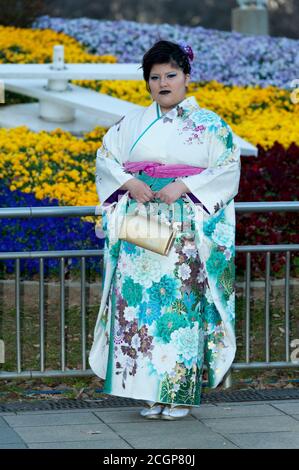 Beautiful Japanese teenager wearing traditional kimono standing looking forward celebrating the Coming of Age Day in Fuji City, Japan. Stock Photo