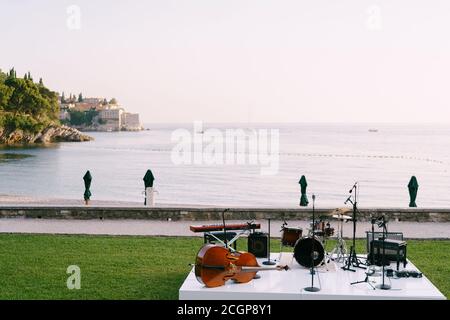 A stage for musicians against the background of the sea and the island of Sveti Stefan in Montenegro. Stock Photo