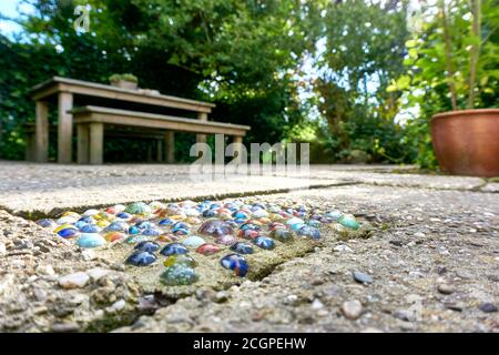 Closeup of multicolored marble balls in concrete as tile on a terrace as garden decoration Stock Photo