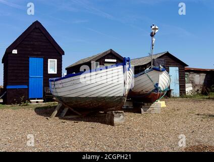 Fishing boats and quirky fishermen's huts are a feature of the foreshore in the the picturesque Southwold Harbour in Suffolk. Stock Photo