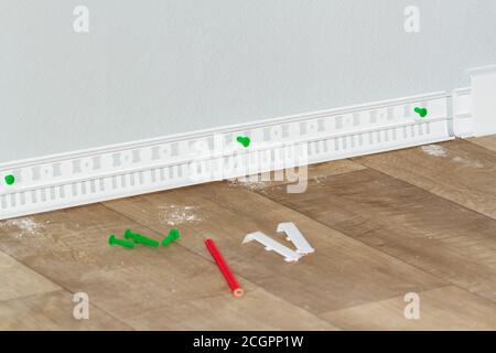 plastic white floor plinth installation Stock Photo