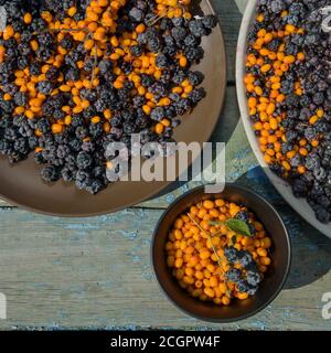 sunny still life of ripe blackberries and buckthorn Stock Photo