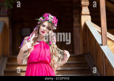 Russia. Moscow, August 27, 2017. Imailovsky park.Parade of brides.Parade of brides.Luxurious blonde girl in bright clothes with on a wooden background Stock Photo