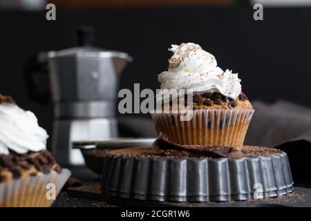 Homemade muffins with coffee and cinnamon. Food still life, dark mood. Stock Photo