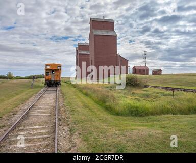 Grain elevators and train caboose in rural Alberta, Canada Stock Photo