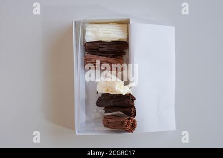 chocolate rolls. chocolate firewood. homemade dark, white and milk chocolate sticks Stock Photo