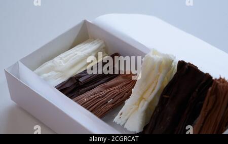 chocolate rolls. chocolate firewood. homemade dark, white and milk chocolate sticks Stock Photo