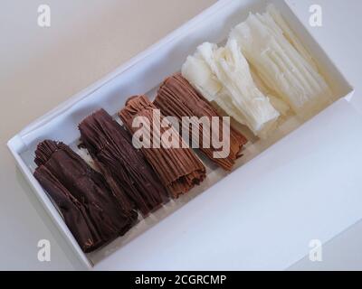 chocolate rolls. chocolate firewood. homemade dark, white and milk chocolate sticks Stock Photo