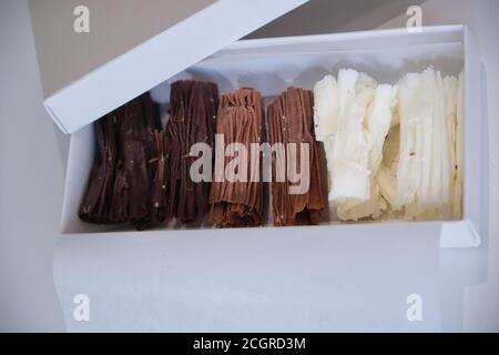 chocolate rolls. chocolate firewood. homemade dark, white and milk chocolate sticks Stock Photo