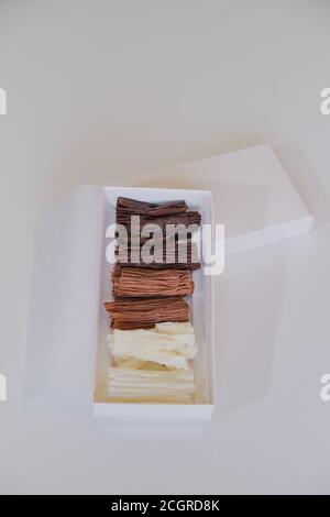 chocolate rolls. chocolate firewood. homemade dark, white and milk chocolate sticks Stock Photo