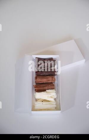 chocolate rolls. chocolate firewood. homemade dark, white and milk chocolate sticks Stock Photo