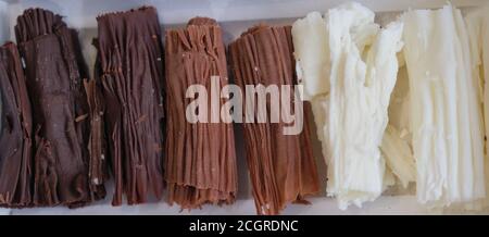 chocolate rolls. chocolate firewood. homemade dark, white and milk chocolate sticks Stock Photo
