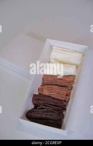 chocolate rolls. chocolate firewood. homemade dark, white and milk chocolate sticks Stock Photo
