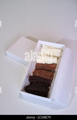 chocolate rolls. chocolate firewood. homemade dark, white and milk chocolate sticks Stock Photo