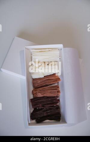 chocolate rolls. chocolate firewood. homemade dark, white and milk chocolate sticks Stock Photo