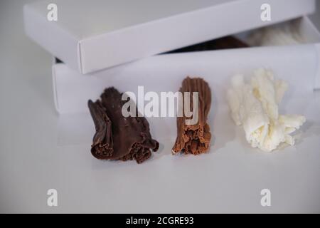 chocolate rolls. chocolate firewood. homemade dark, white and milk chocolate sticks Stock Photo
