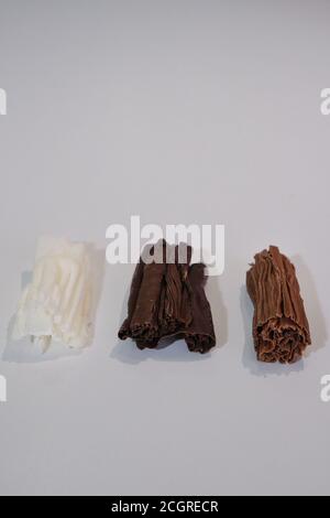 chocolate rolls. chocolate firewood. homemade dark, white and milk chocolate sticks Stock Photo