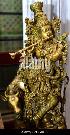 A Fine detailed Brass Hand made Statue of Lord Krishna With Flute and Cow. Stock Photo