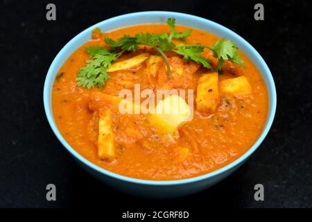 Paneer butter masala is a rich and creamy dish of paneer (cottage cheese) in a tomato, butter and cashew sauce Stock Photo